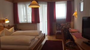 En eller flere senger på et rom på Hotel Camona & Apart Walserhof