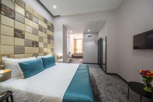 Postel nebo postele na pokoji v ubytování Hotel President
