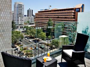 a balcony with a view of a city at America Diamonds Hotel in Lisbon +33 photos