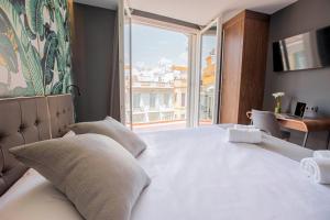 Posteľ alebo postele v izbe v ubytovaní Málaga Premium Hotel