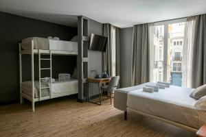 Posteľ alebo postele v izbe v ubytovaní Málaga Premium Hotel