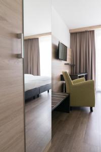 TV a/nebo společenská místnost v ubytování Taste Style Hotel Bären Auggen
