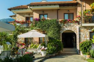 a building with an archway and flowers in front of it at Nikoleta Luxury Villa in Limenas