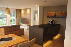 a kitchen and living room with a couch and a table at Ferienwohnung Emde in Willingen