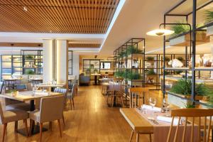 a restaurant with tables and chairs in a room at Iberostar Selection Jardín del Sol Suites - Adults Only in Santa Ponsa