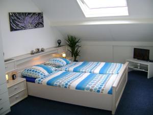 a bed room with a white bed and a blue and white bedspread at Enschede in Enschede