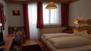 En eller flere senger på et rom på Hotel Camona & Apart Walserhof