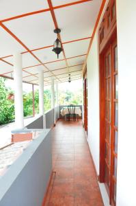 an empty porch of a house with a ceiling at Ajanthas' Homestay in Kandy