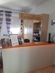 a reception desk with a sign that reads reputation at Hotel Schweizer Stubb in Kaiserslautern