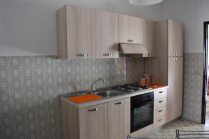 cocina con fregadero y fogones horno superior en Casa Skanderbek, en Civita