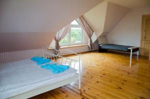 a bedroom with a bed with blue sheets and a window at Beautiful & Big Family Villa in Klaipėda