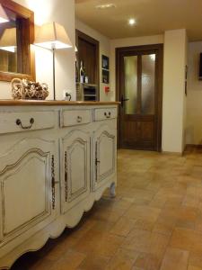 
a kitchen with white cabinets and wooden floors at Hotel Areulo in Cerler
