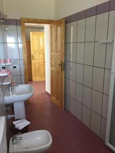 a bathroom with a toilet, sink and shower at Hotel Punto Azzurro in Ischia