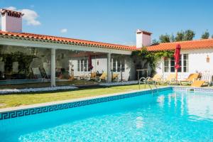 a swimming pool in front of a house at Horta da Fonte in Alburitel