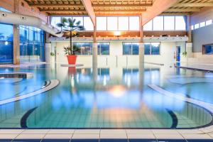 a large swimming pool in a building with a large pool at Les Terrasses d'Atlanthal in Anglet