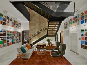 a living room with two chairs and a staircase at Arlo NoMad in New York