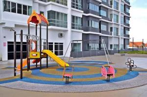 um parque infantil em frente a um edifício de apartamentos em Sekinchan Happiness Homestay em Sekincan