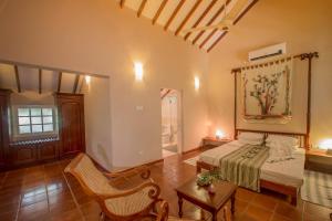 a bedroom with a bed and a table and a chair at Sigiriya Village in Sigiriya