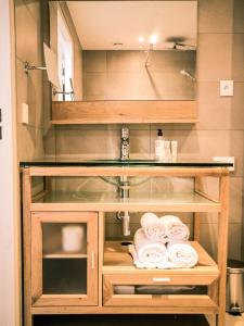 a glass cabinet with rolled towels in a bathroom at Best Western Plus Antibes Riviera in Antibes