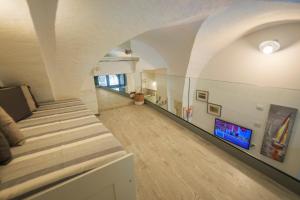 a room with a bed and a hallway at Dammuso di Ponente Ortigia in Siracusa