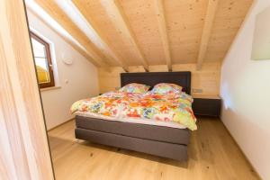 a bed in a small room with a wooden ceiling at Ferienhaus Albzeit in Albstadt