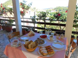 a table with plates of food on top of a balcony at Accommodation Susović in Lastovo