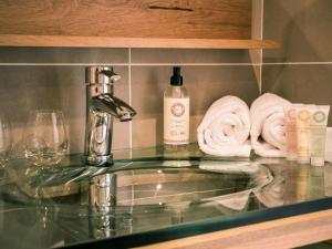 a bathroom counter with a sink and towels at Best Western Plus Antibes Riviera in Antibes