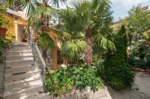a staircase leading up to a building with a palm tree at Apartments Center Opatija Ziric in Opatija