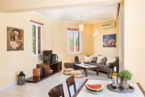 a living room with a couch and a table at Daphnis Villas in Maleme