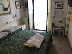 Postel nebo postele na pokoji v ubytování Hotel Byron