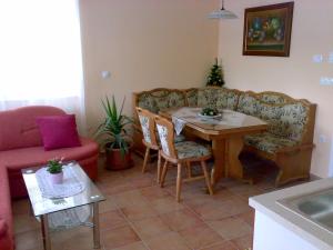 a living room with a table and a couch at Apartments and Rooms With View on Bled in Bled