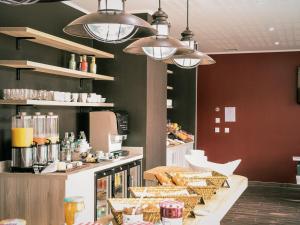 a kitchen with a counter with bread and other foods at Best Western Plus Antibes Riviera in Antibes