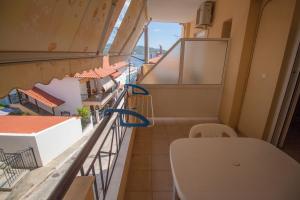 a balcony with a toilet on a building at PortoDream Studios & Apartments in Neos Marmaras