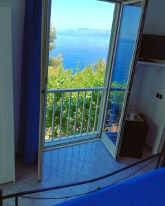 a room with a view of the ocean from a balcony at Zia Yaya in Maratea