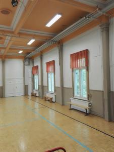 an empty room with benches and windows in a gym at Retkeilymaja Virkkula in Kuopio