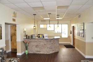 a lobby with a bar in the middle of a building at Orlando RV Resort in Orlando