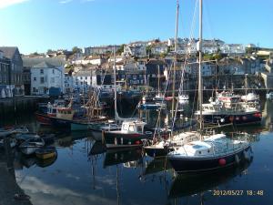 a group of boats are docked in a harbor at TopHeavy Cottage Mevagissey in Mevagissey