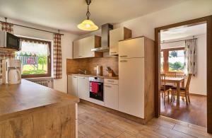 a kitchen with a white refrigerator and a table at Ferienhaus Fidelis in Bodenmais