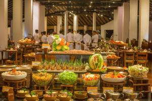 a buffet of food with people in the background at Sigiriya Village in Sigiriya