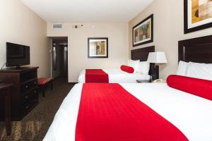 a hotel room with two beds and a flat screen tv at Century Casino & Hotel Edmonton in Edmonton