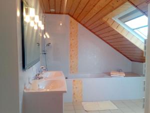 a bathroom with two sinks and a bath tub at Gite de Kerantum in Mahalon +30 photos