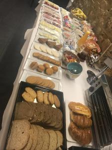 a tray of sandwiches and pastries on a table at Hotel Lois in A Coruña