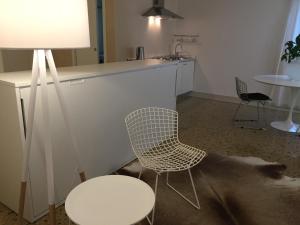 a room with a table and a chair and a sink at Ca' Bert Villa dei Glicini B&B in Castelnuovo del Garda