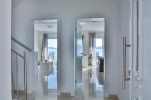 a hallway with three glass doors in a room at Apartments & Rooms Kata - Adults Only in Senj +78 photos
