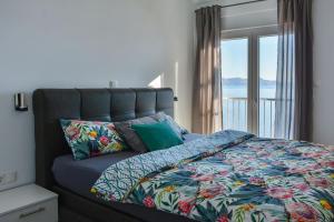 a bedroom with a bed with a view of the ocean at Apartments & Rooms Kata - Adults Only in Senj