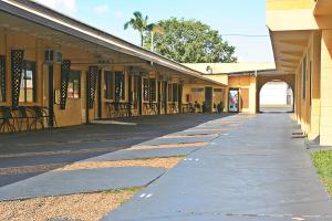 an empty walkway in front of a building at Bourbong St Motel in Bundaberg