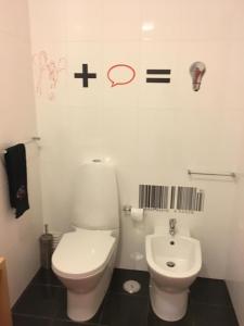 a white bathroom with a toilet and a sink at Nazaré T2 Vista Mar in Nazaré