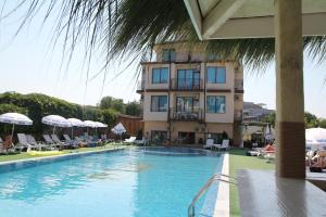 a hotel with a swimming pool in front of a building at Salena Hotel in Primorsko