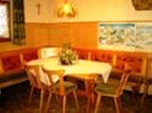 a dining room with a white table and chairs at Ferienwohnung Zick in Sankt Gallenkirch