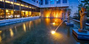 a fountain in the middle of a building at SSAW Boutique Hotel Nanchang Bayi Square in Nanchang